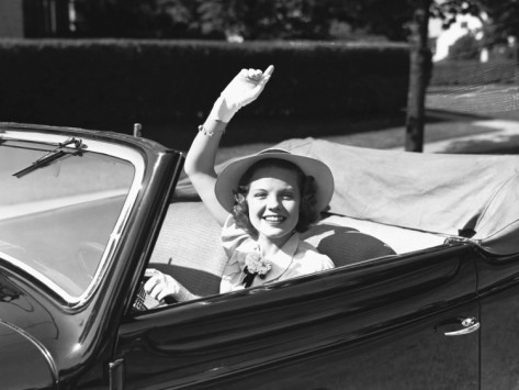 george-marks-elegant-woman-in-convertible-car-waving-portrait.jpg